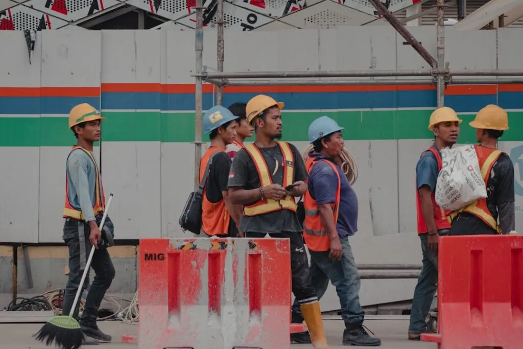 Trabalhadores Da Construcao Civil Com Capacetes E Coletes No Local t1IFKdfQTk